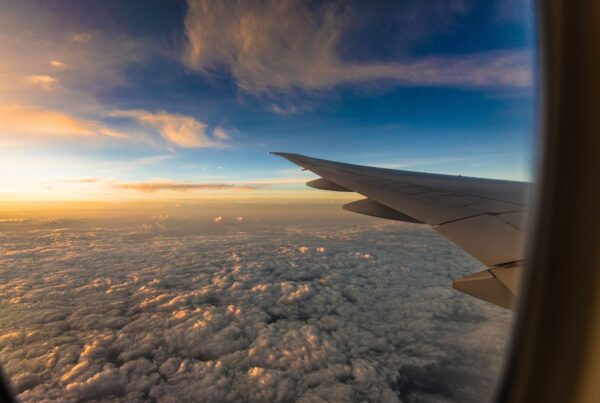 tips for long flights view from plane window down onto clouds