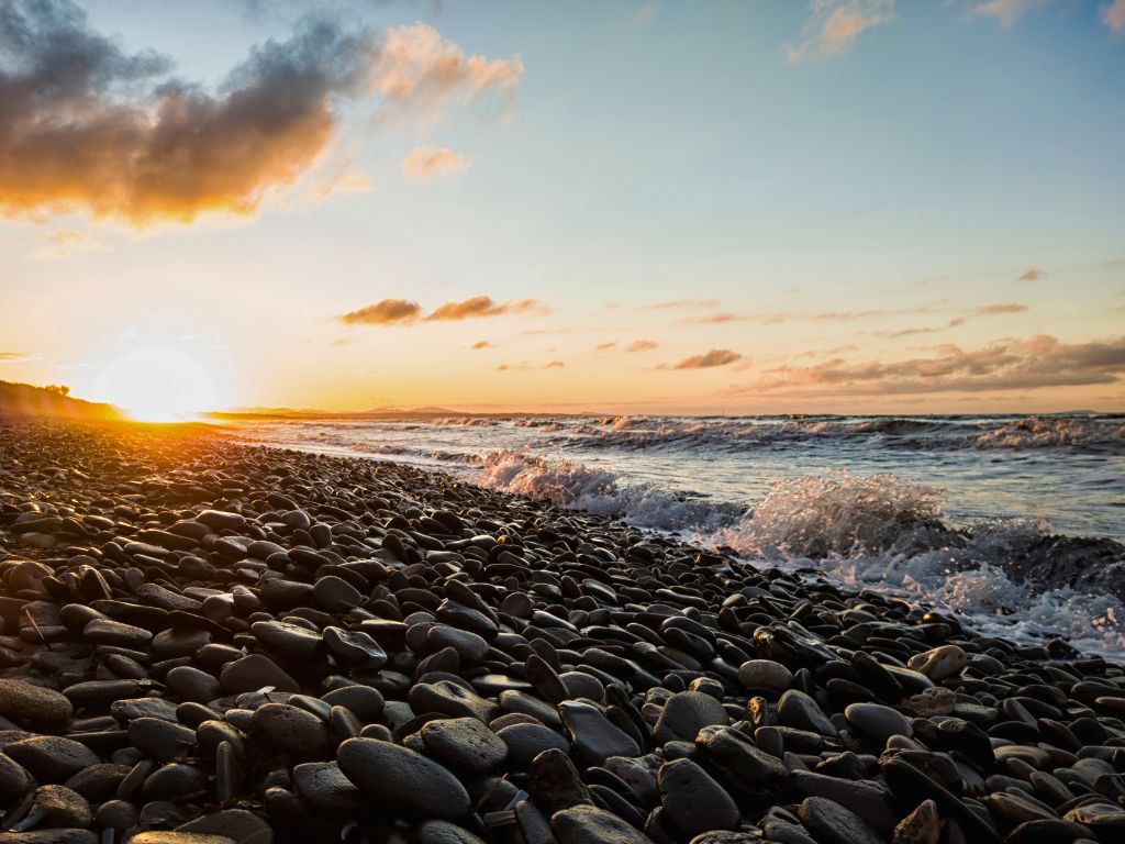 sardinia pebble beach at sunset