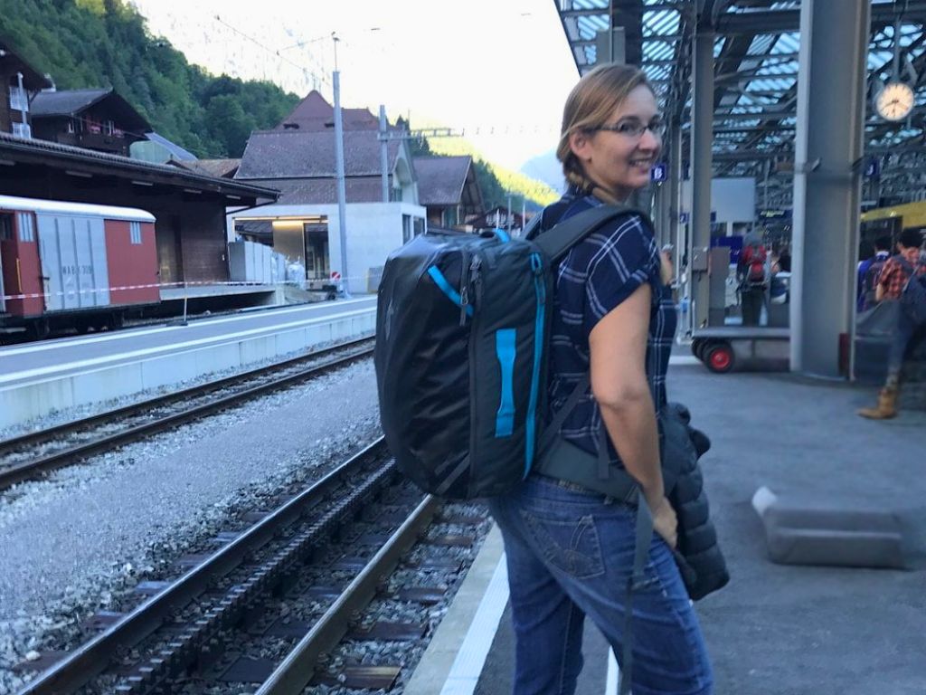 sarah posing with backpack on at train station