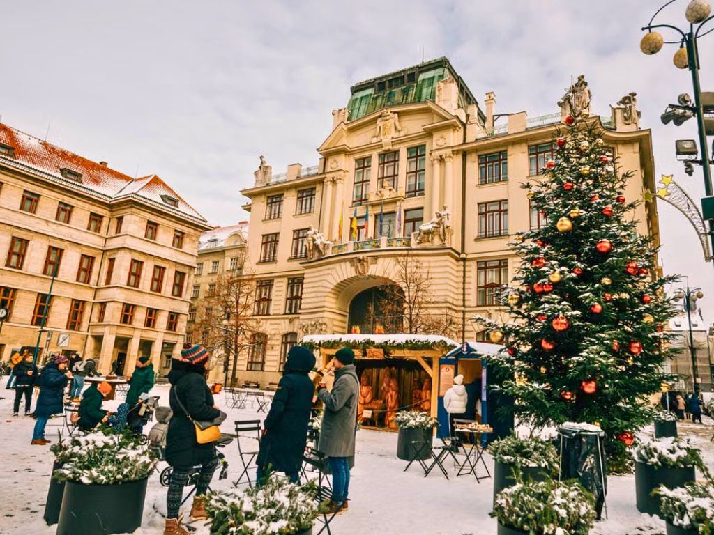 czech christmas traditions prague market with christmas tree in the snow