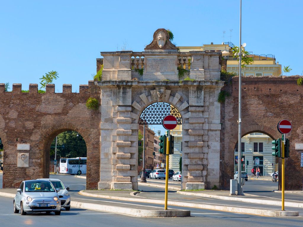 porta san giovanni  and walls with modern road between
